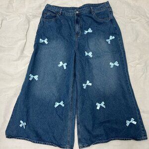 Wide leg blue jeans with powder blue bows scattered on front from CIDER